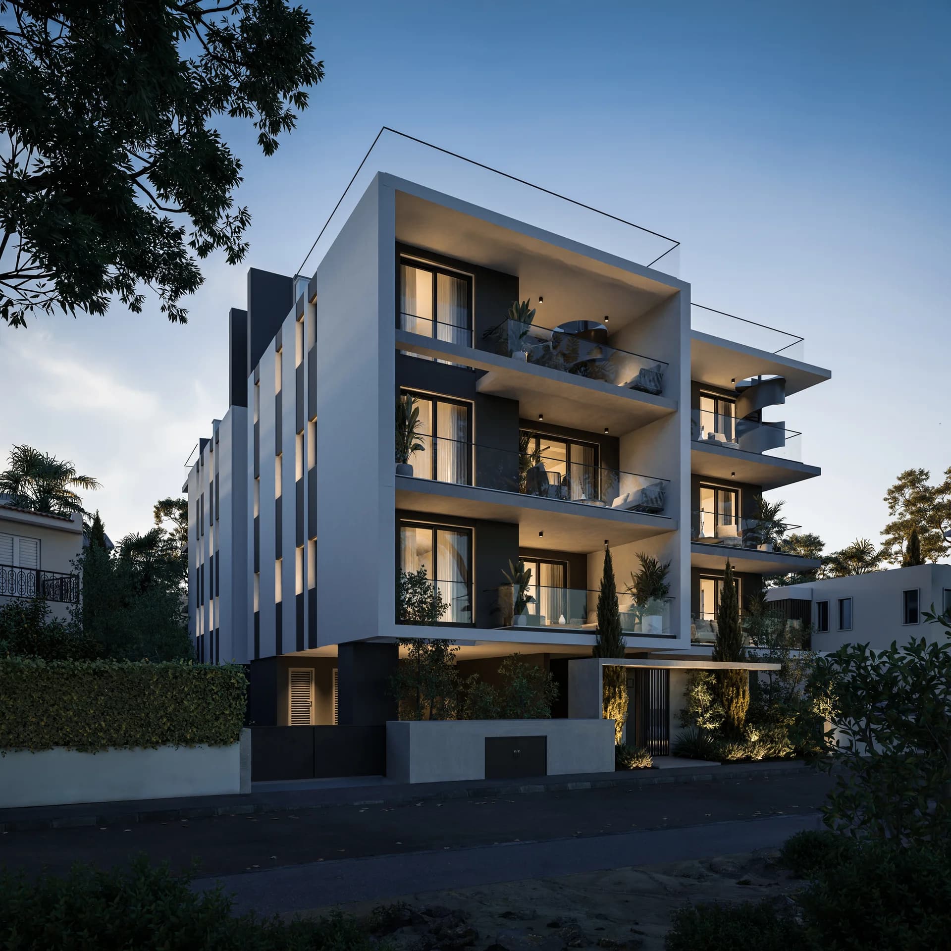 ACHILLEAS at dusk, its balconies lit among trees