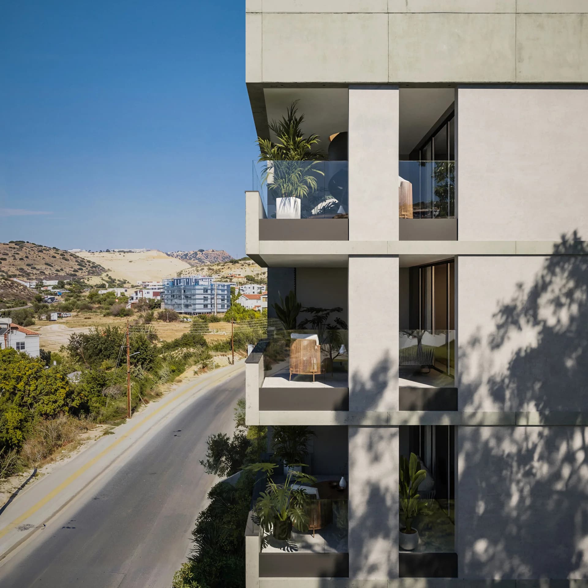 ALDO's balconies above the road, with the hills of Agios Athanasios behind