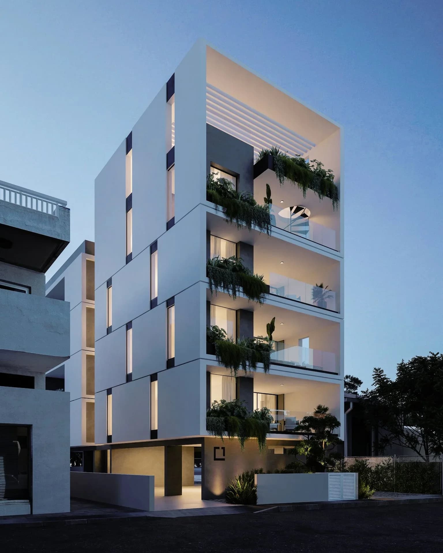 ANAIS at dusk, planted balconies lit along a white stepped facade