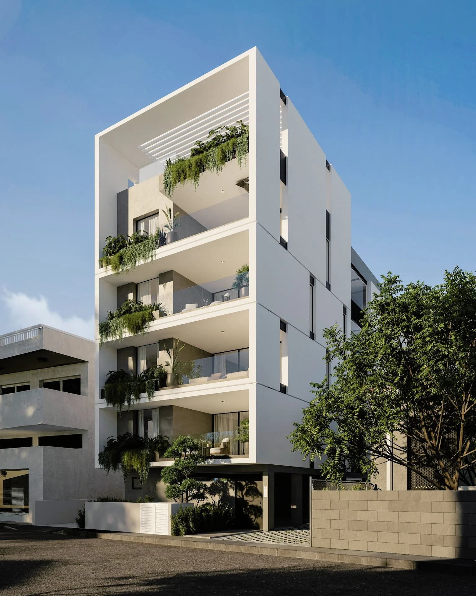 ANAIS's white facade with planted balconies rising beside a tree