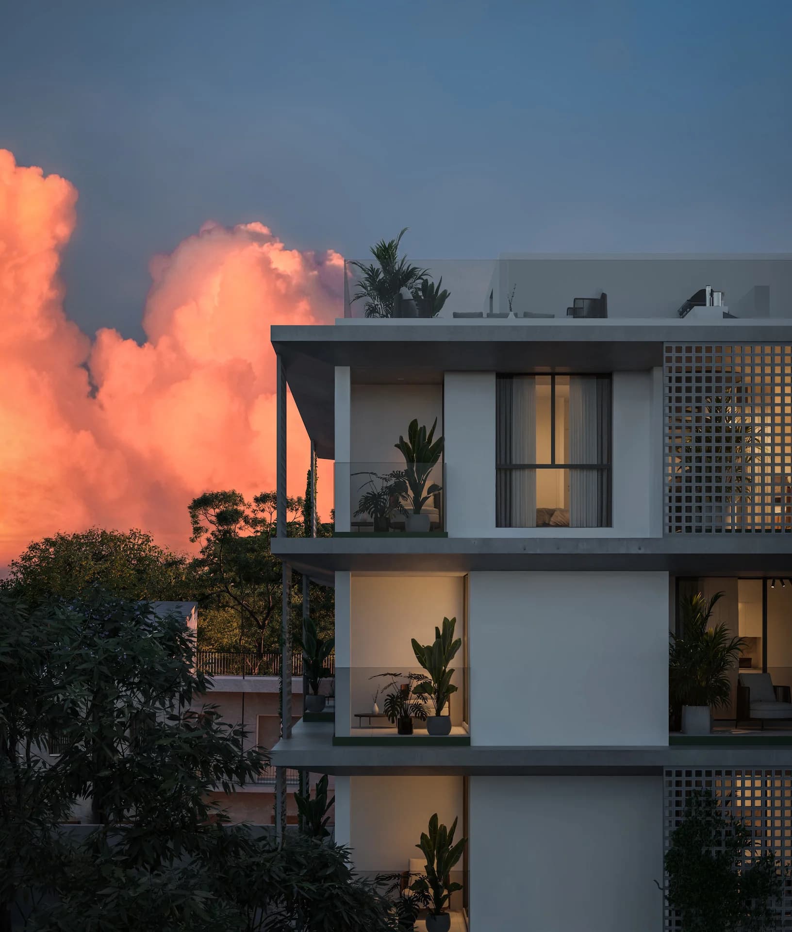 AURA's upper balconies against a pink sunset sky