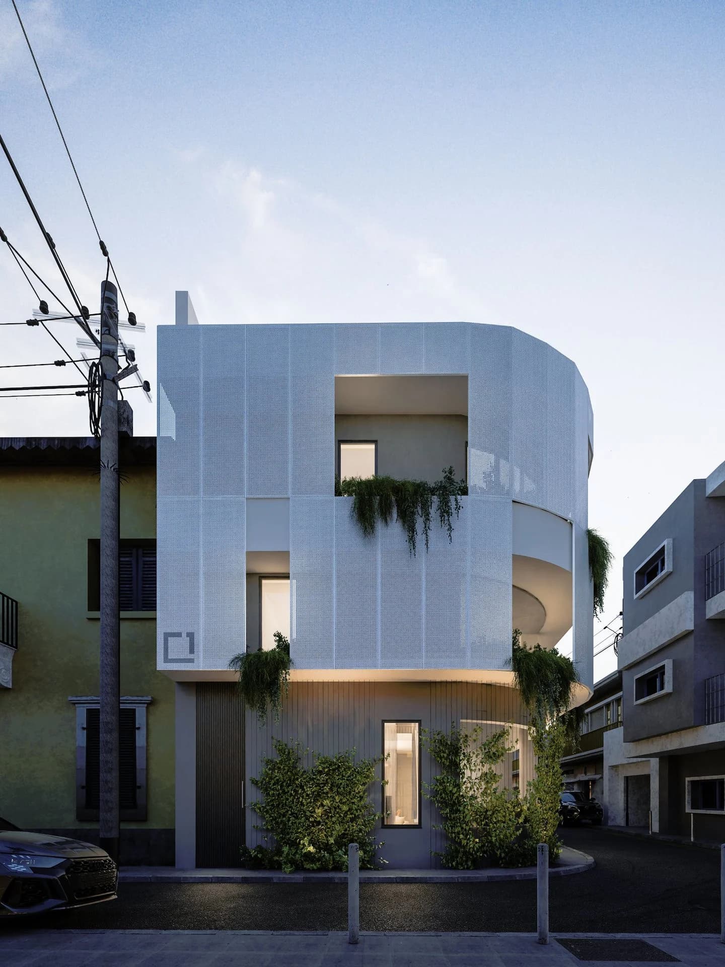 HARLIR's white perforated facade with hanging plants on a narrow old-town street