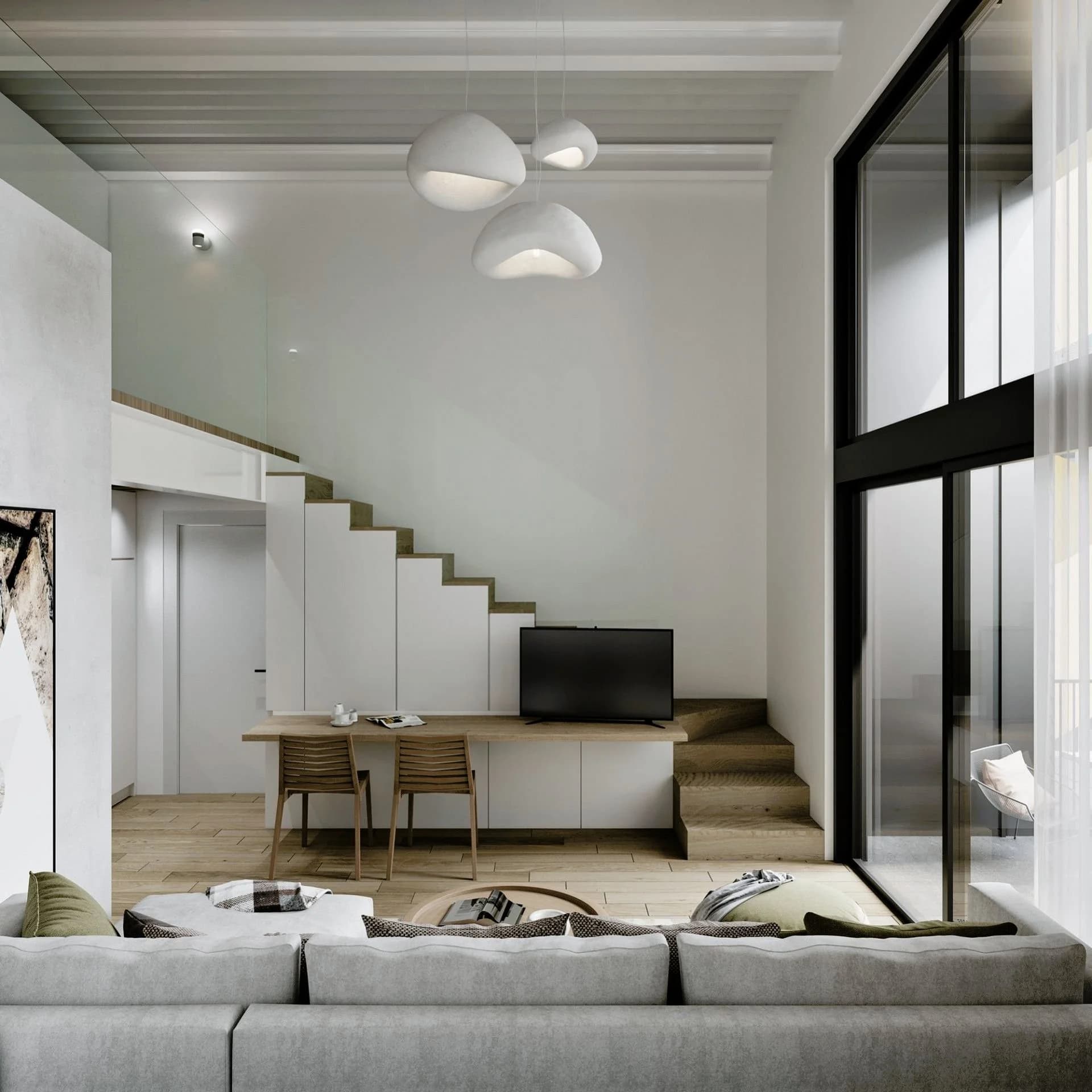HARLIR studio with a desk and a stair up to the sleeping loft