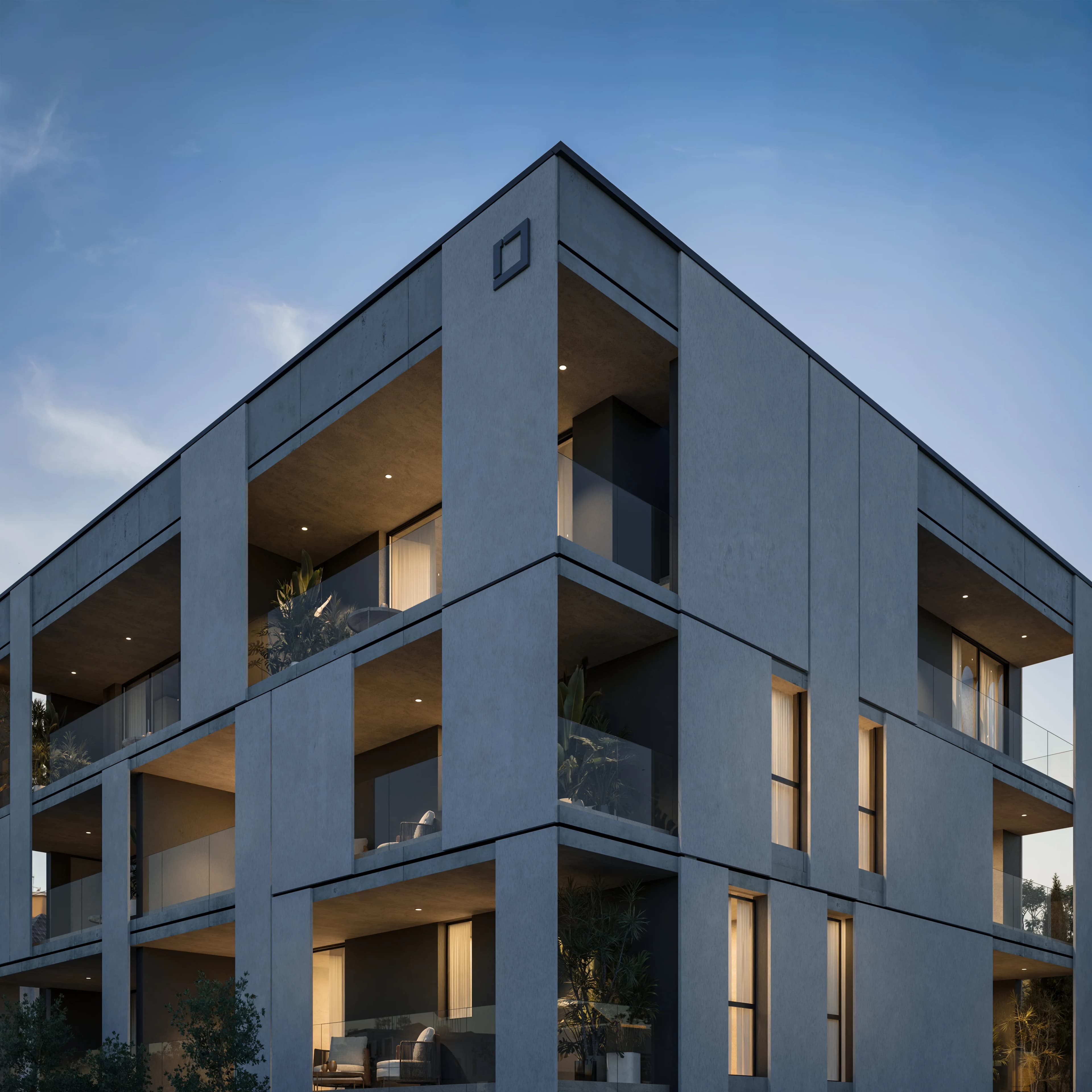 Corner of KAIA with deep framed balconies against the evening sky