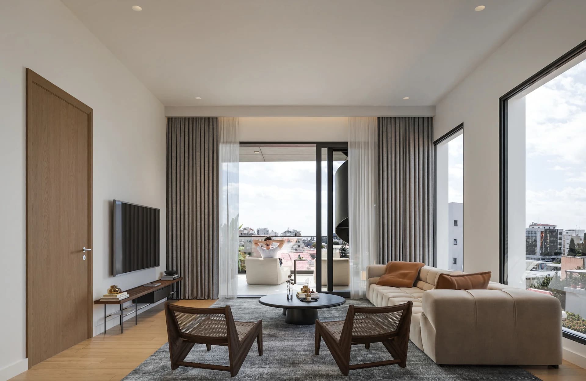 LAV living room opening onto a balcony with city views