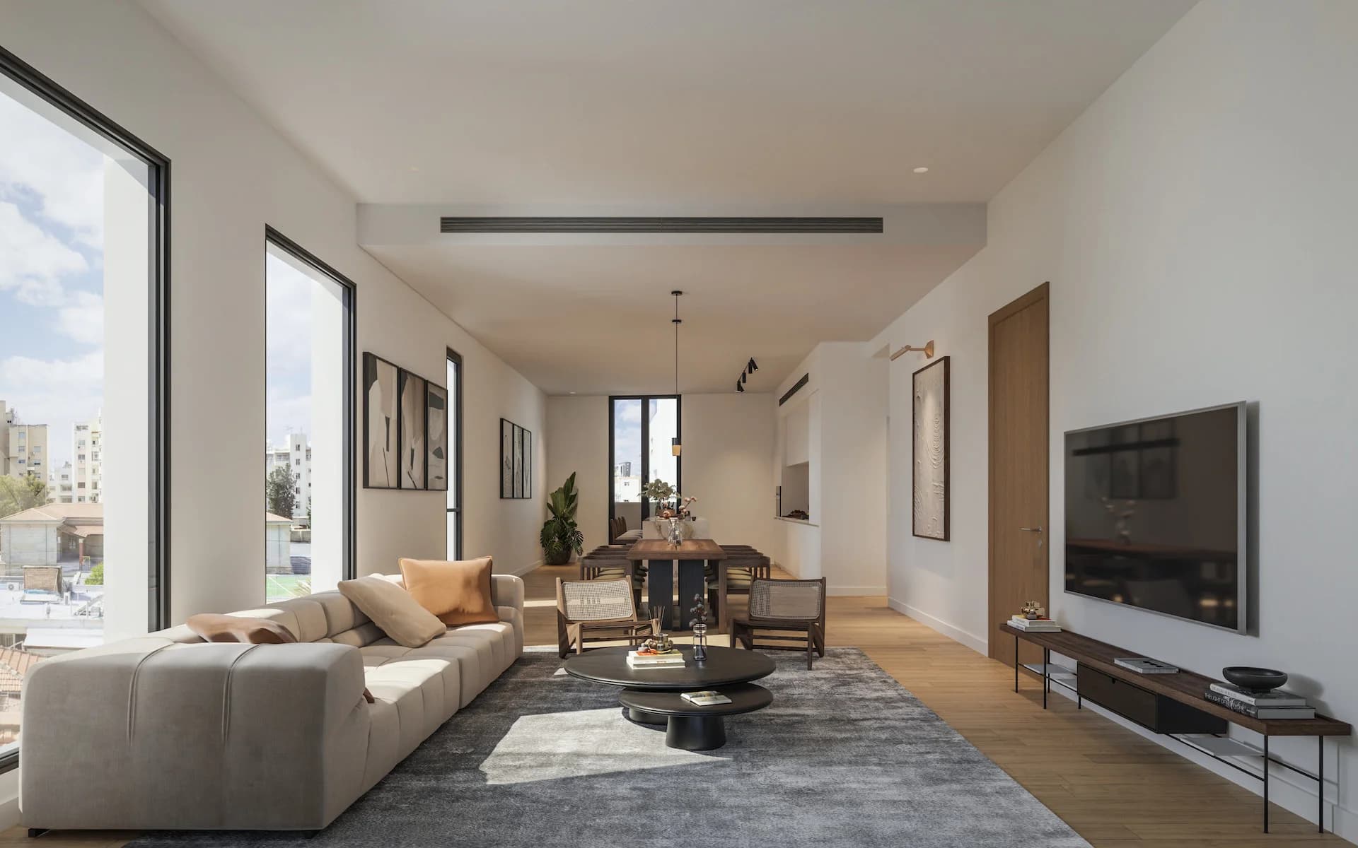 Long LAV living room with large windows and a dining table beyond