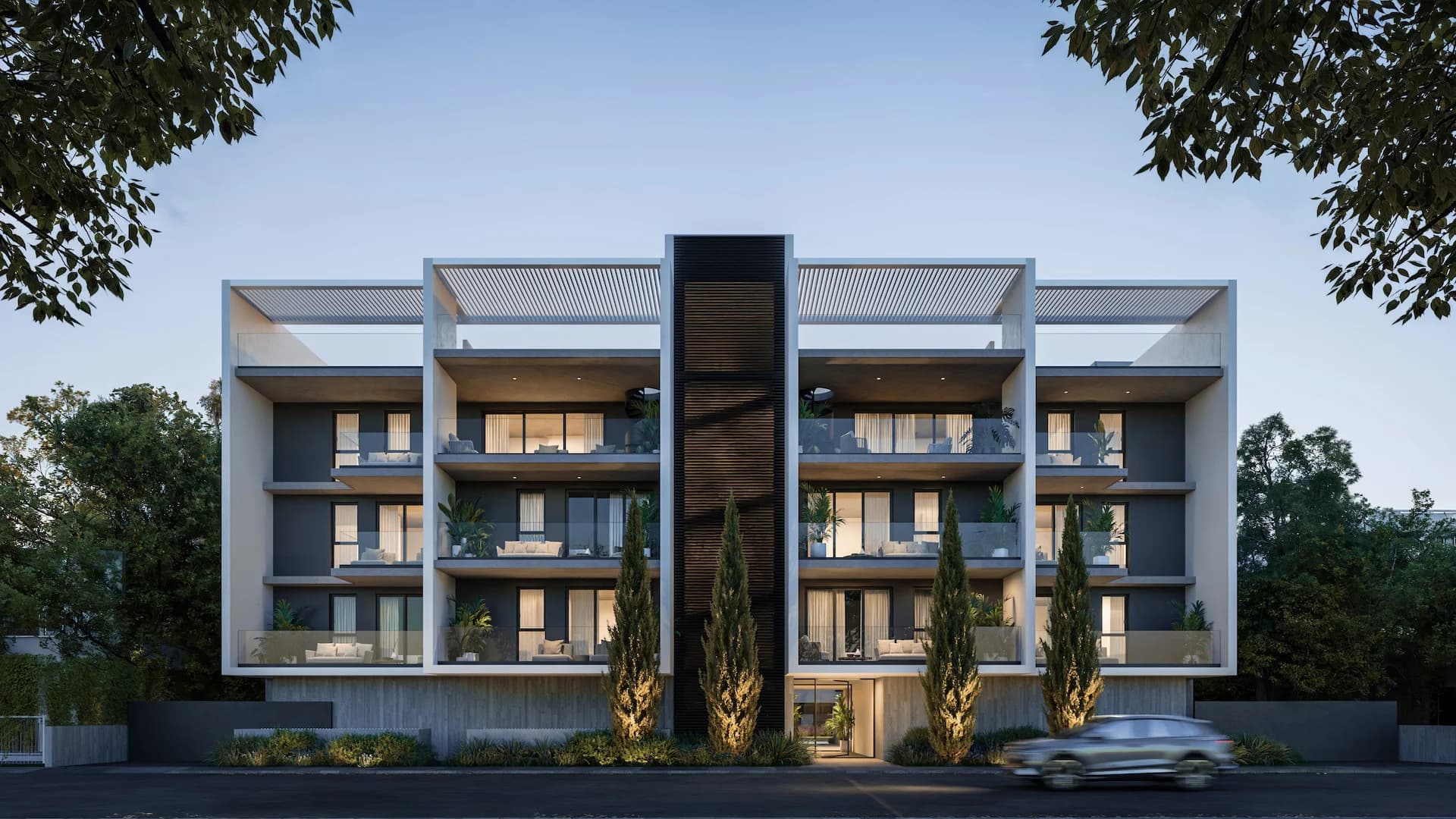 LENNOX's white four-storey facade at dusk with a central stair tower and cypress trees