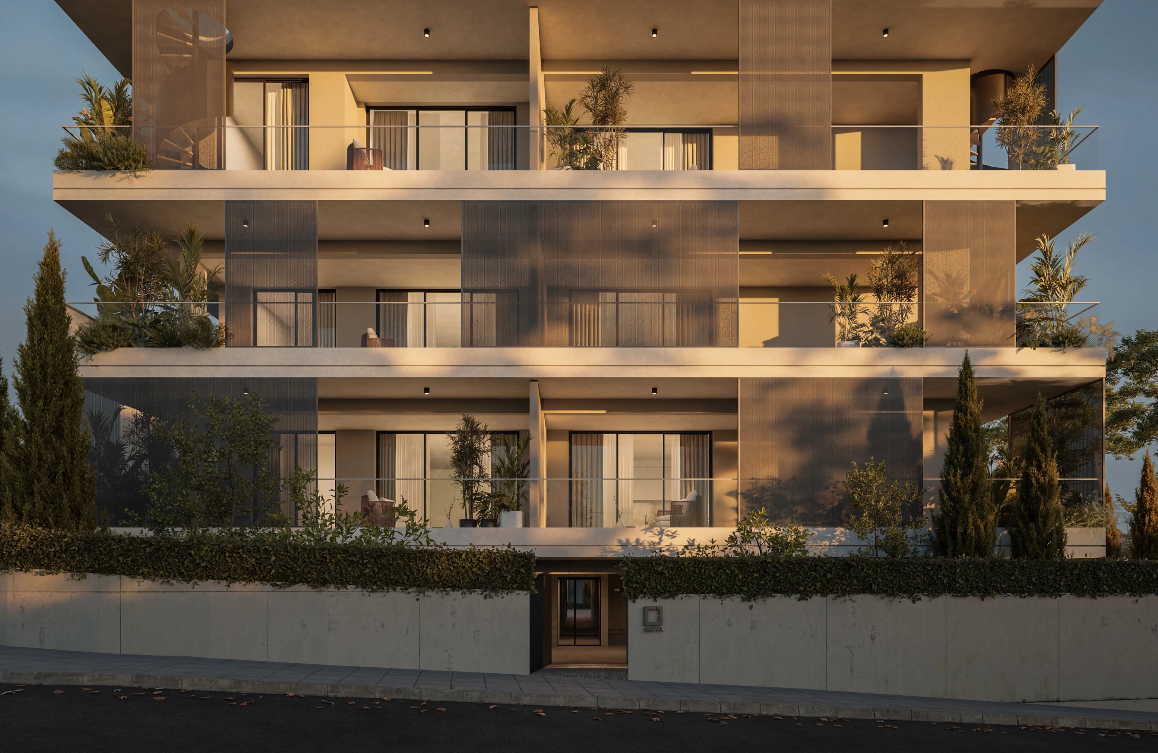 Warm evening light on NAYA's balconies and planted entrance