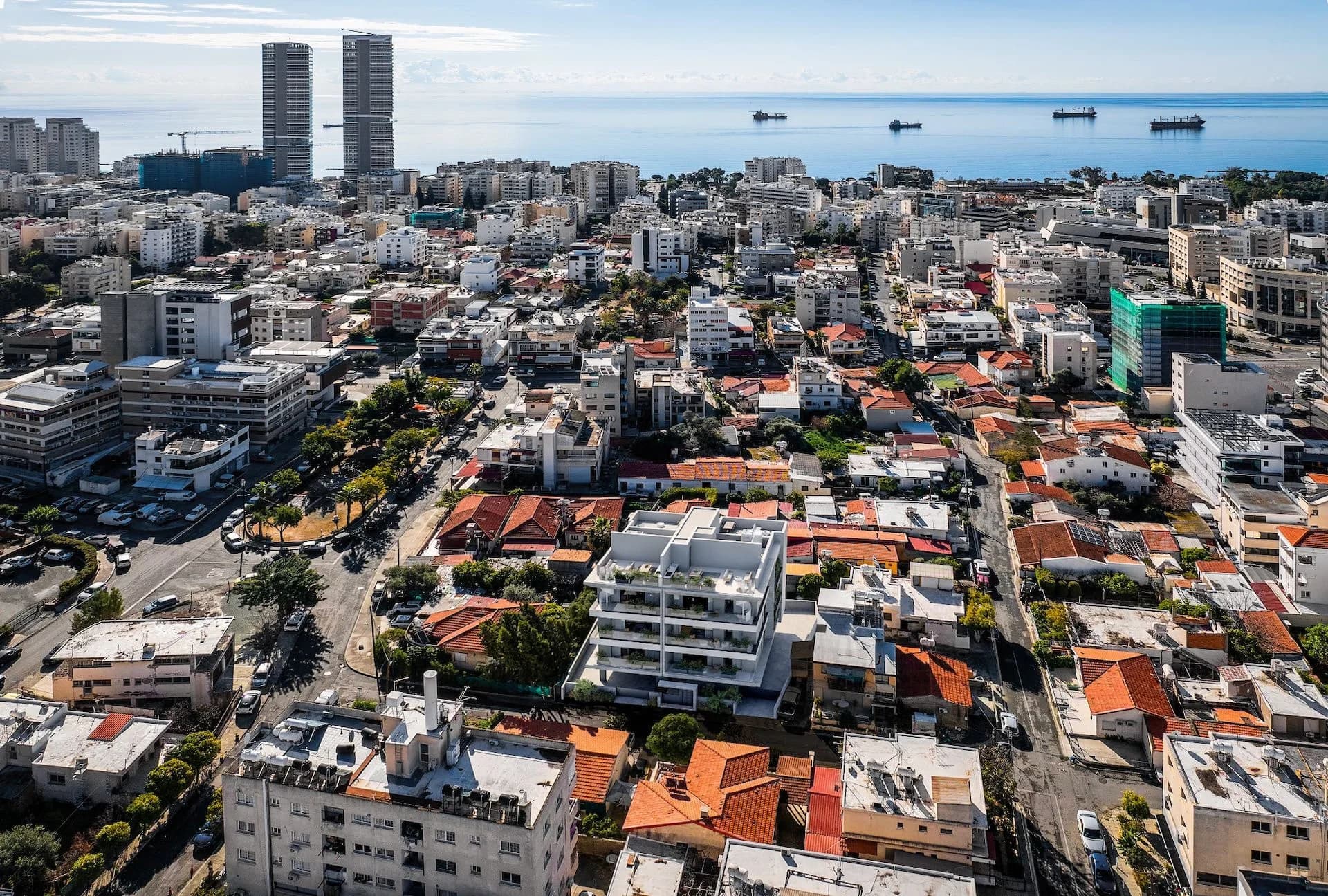 Aerial view of NEVE in Agios Nikolaos, with Limassol's towers and the sea beyond