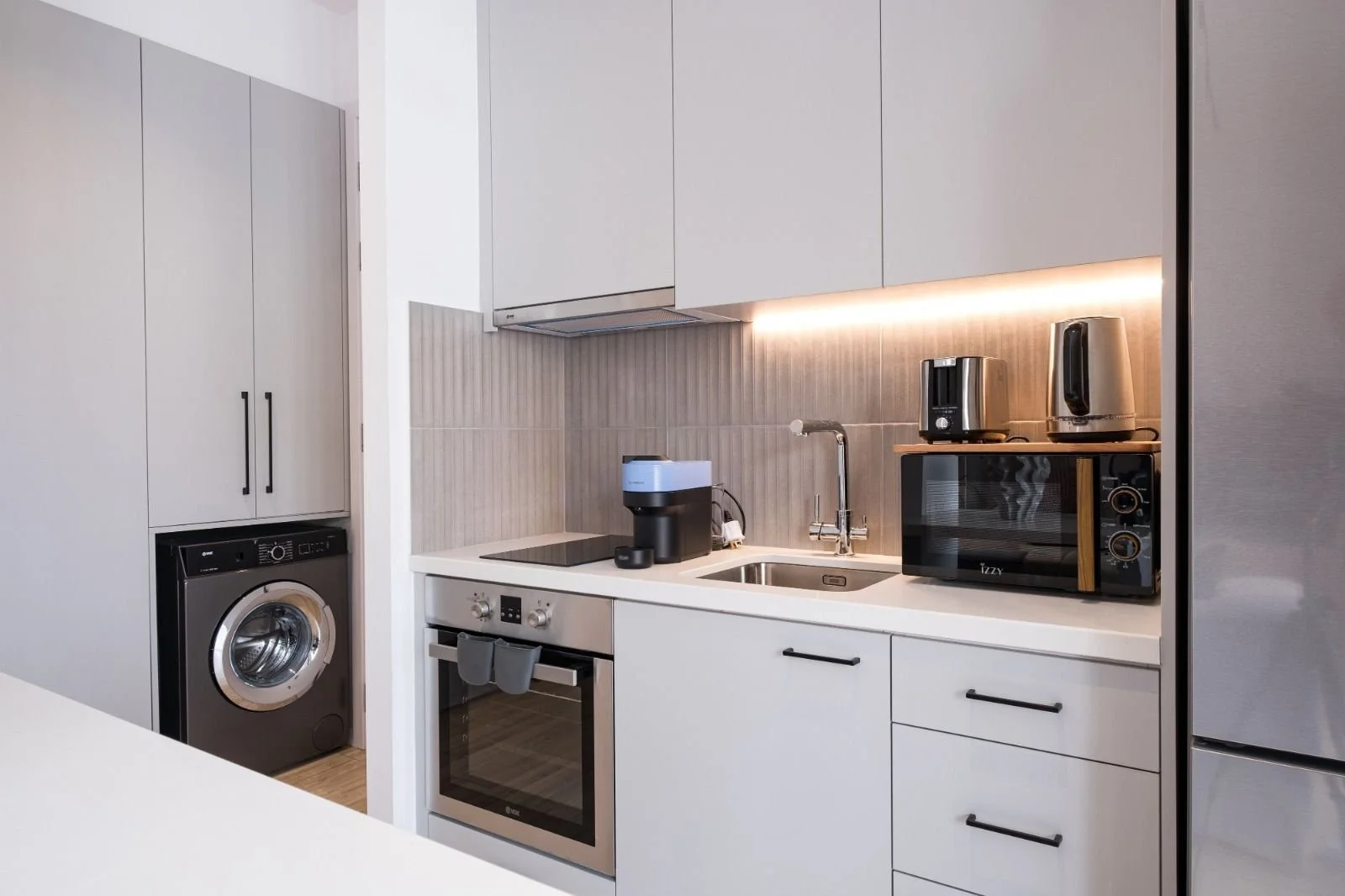 OLYMPIA kitchenette with a washing machine and oven