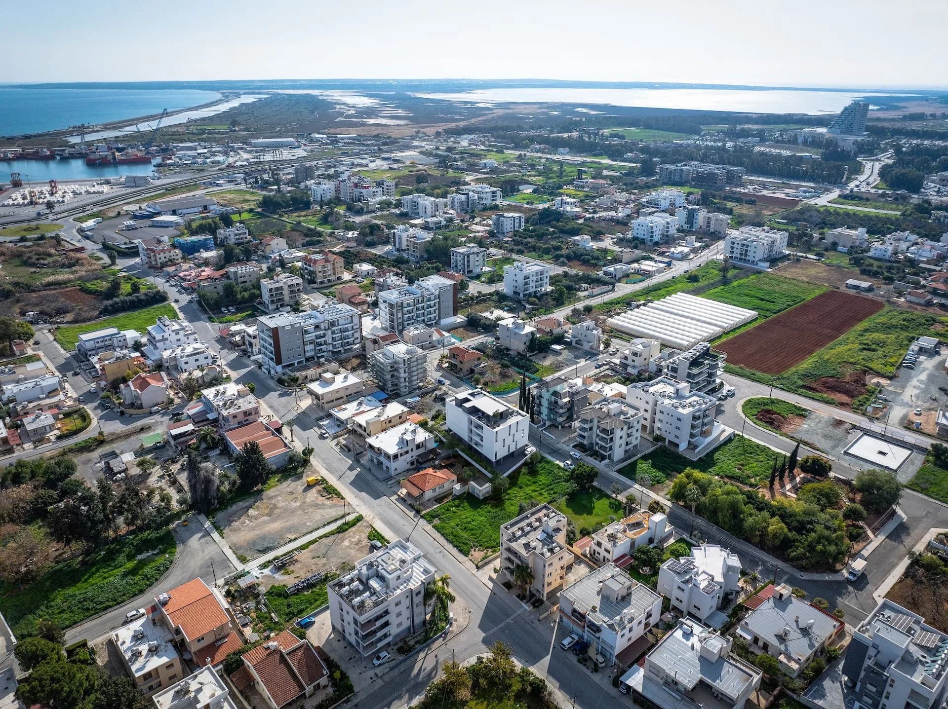 Aerial view of Zakaki around PLAYA, with Limassol's port and the sea beyond