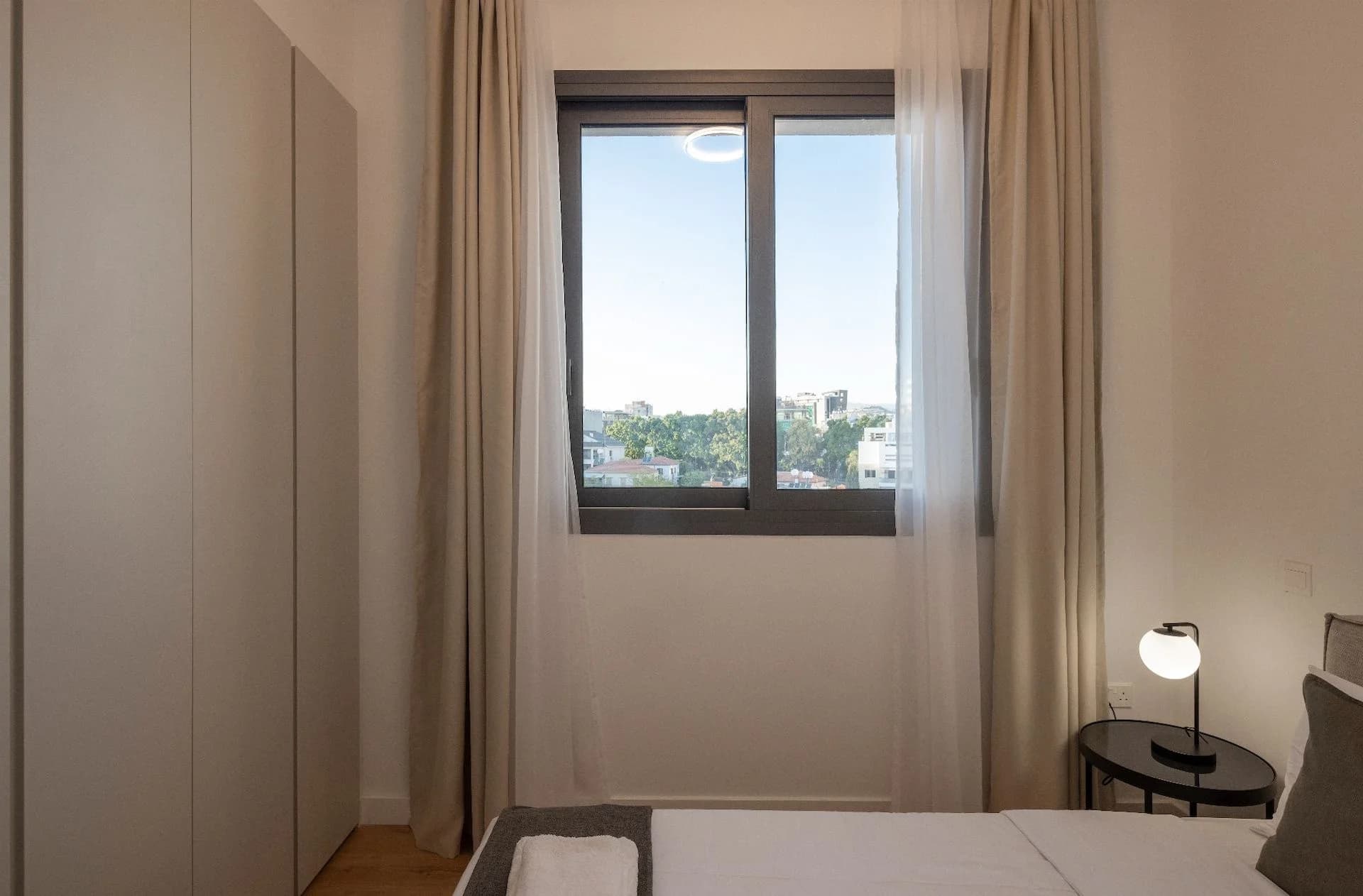 SEQUOIA bedroom with sheer curtains and a garden view