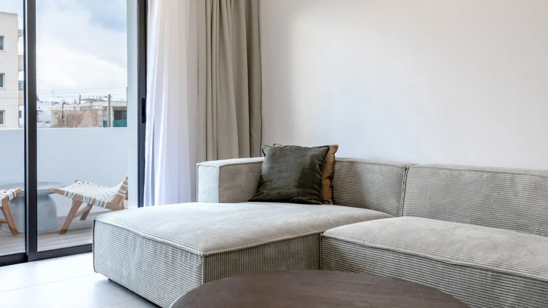 SILENE living room with glass doors onto a balcony over the street