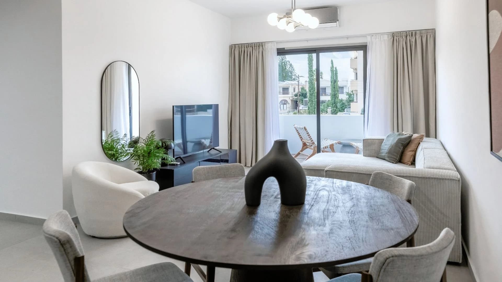SILENE dining table and living area with a balcony beyond