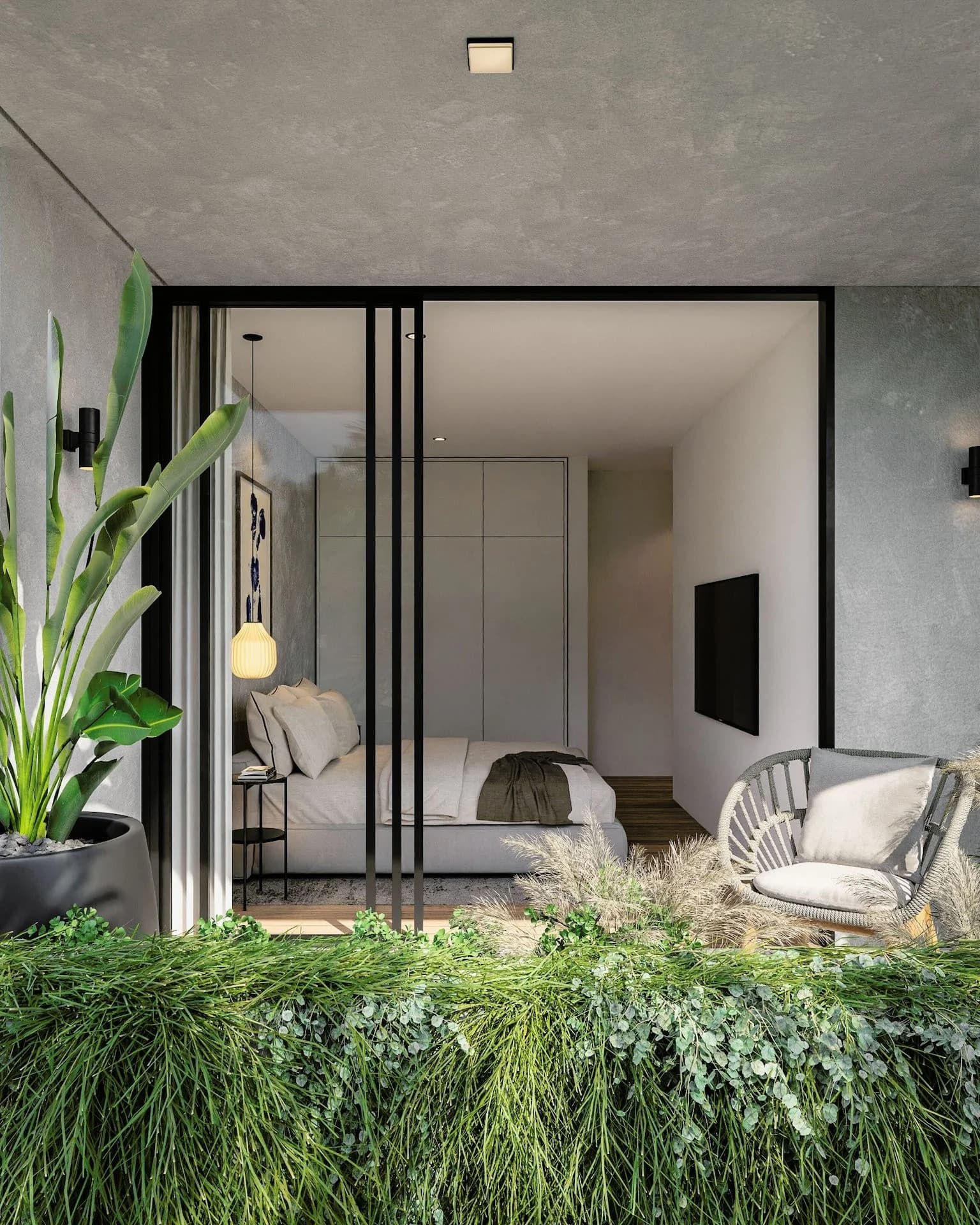 SOL bedroom behind slim black glazing, a lounge chair and plants beside it