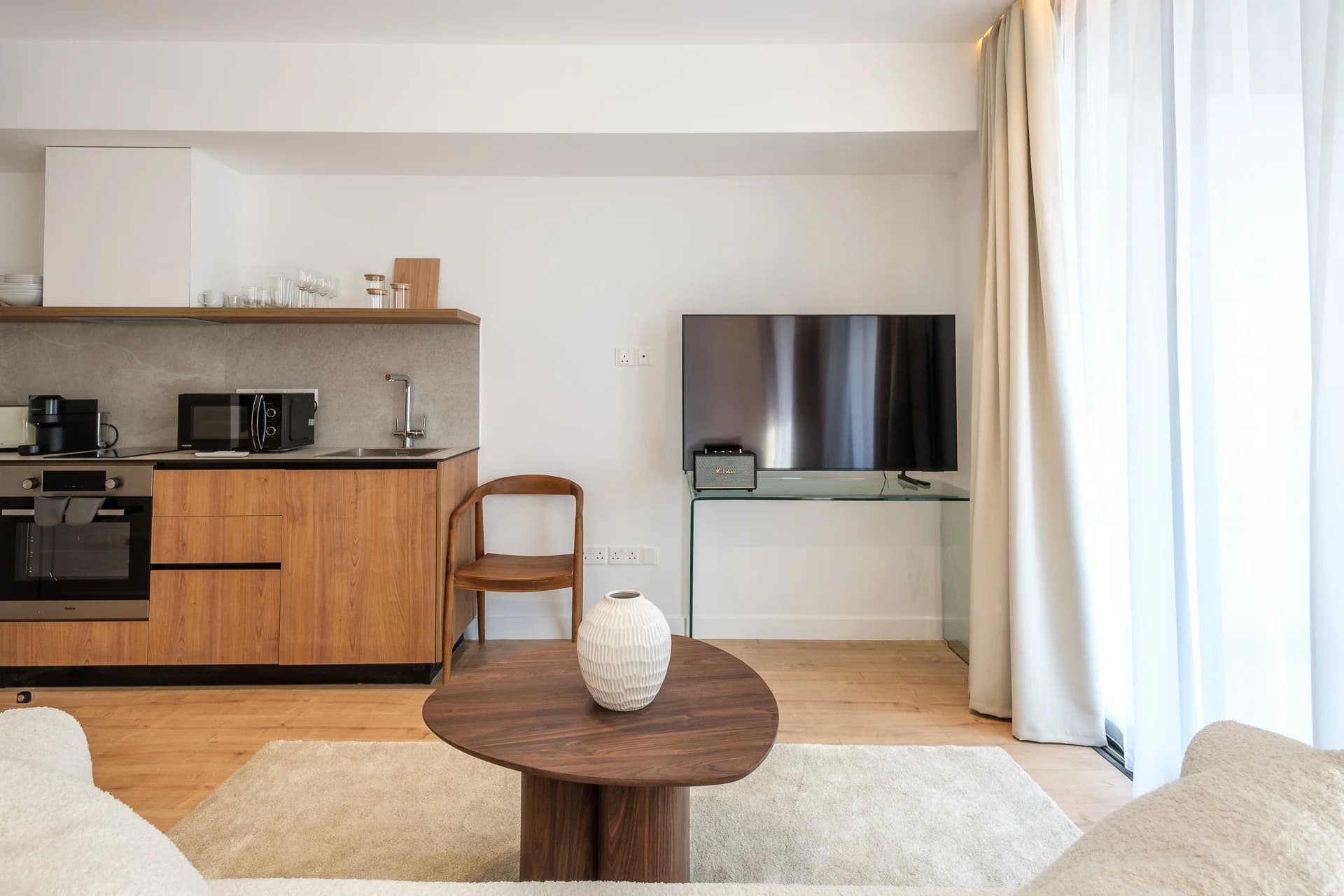 STAY 1 studio living area with a round table and kitchen
