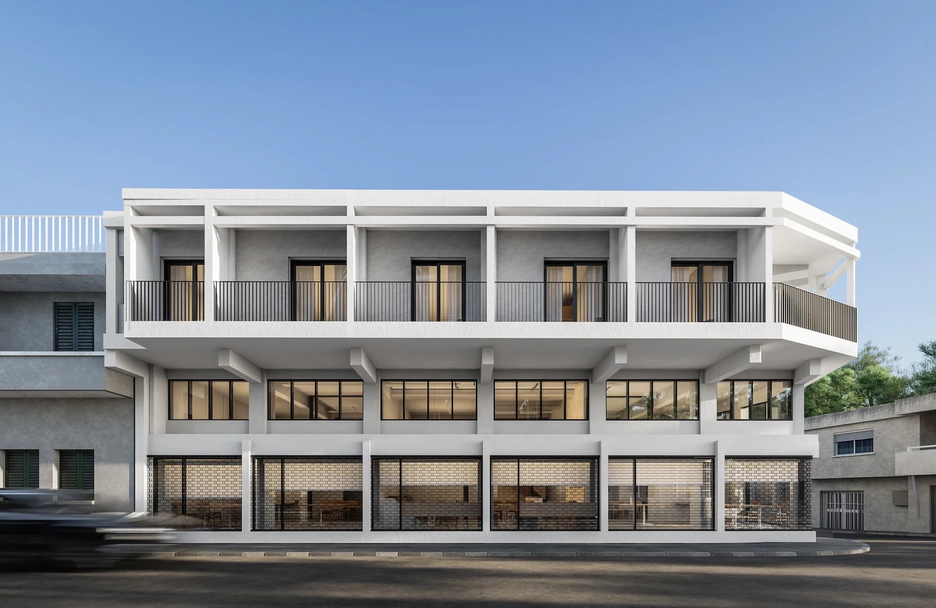 STAY 4's white two-storey facade with balconies above glazed ground-floor units