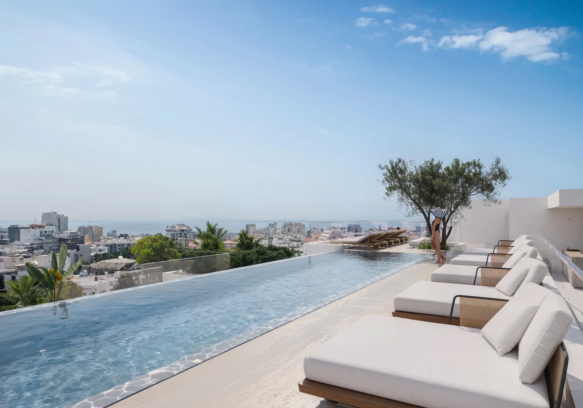 Rooftop infinity pool at THE COLLECTION with sun loungers and views to the sea