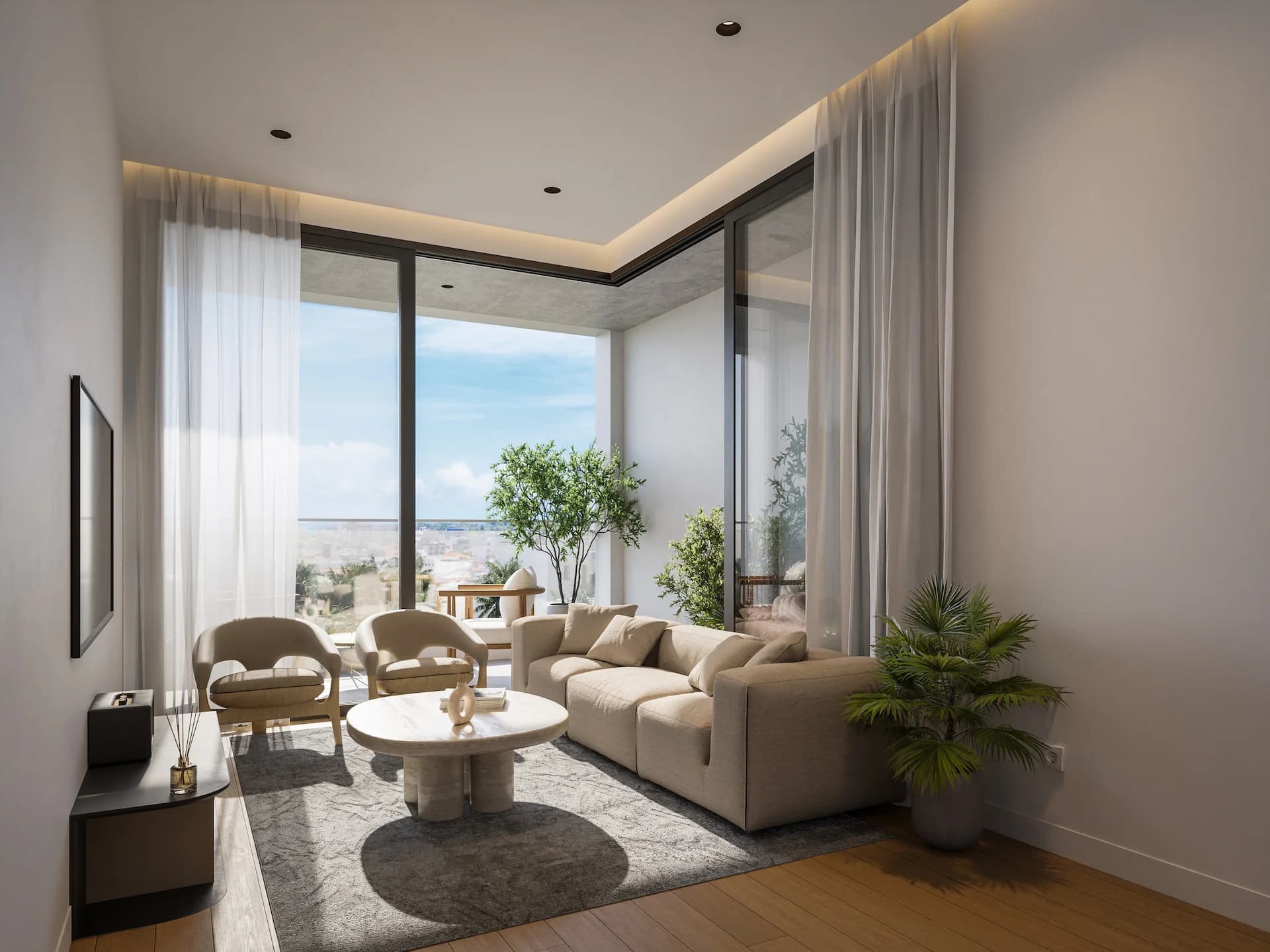 THE COLLECTION living room with tall windows and a view out to the sea