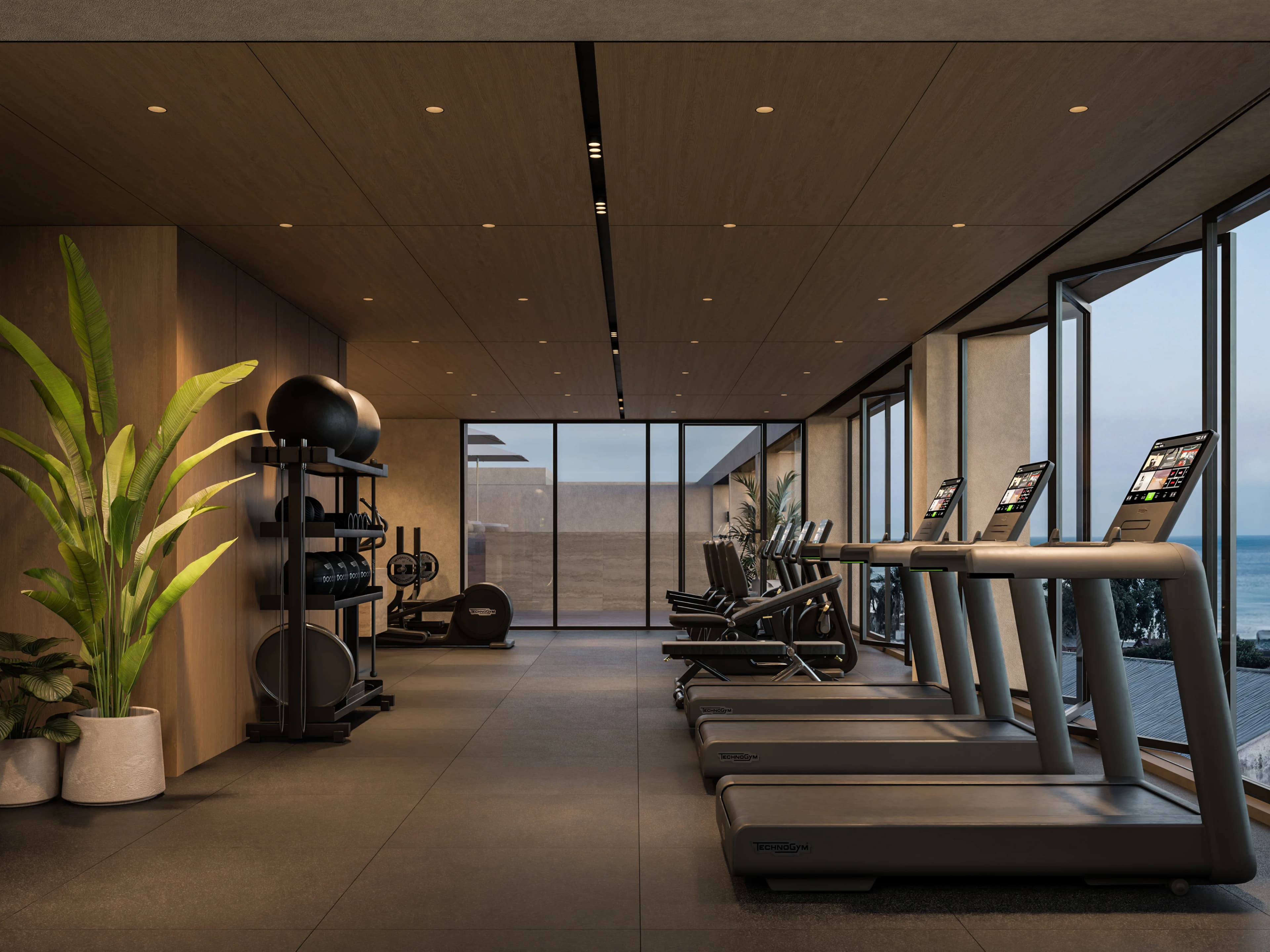 THE DOCKS gym with treadmills facing floor-to-ceiling windows