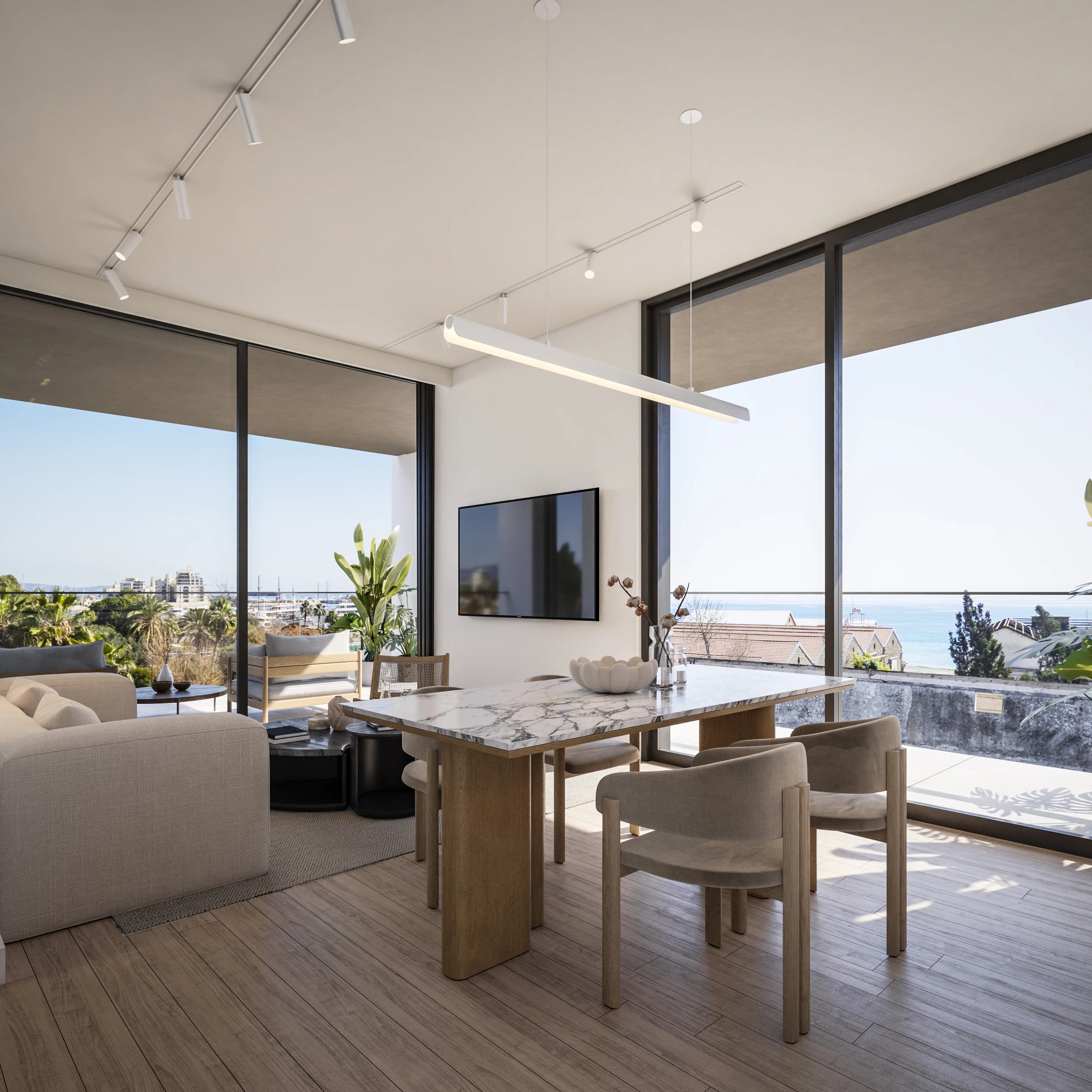 Marble dining table at THE DOCKS beside glass walls with a view of the sea