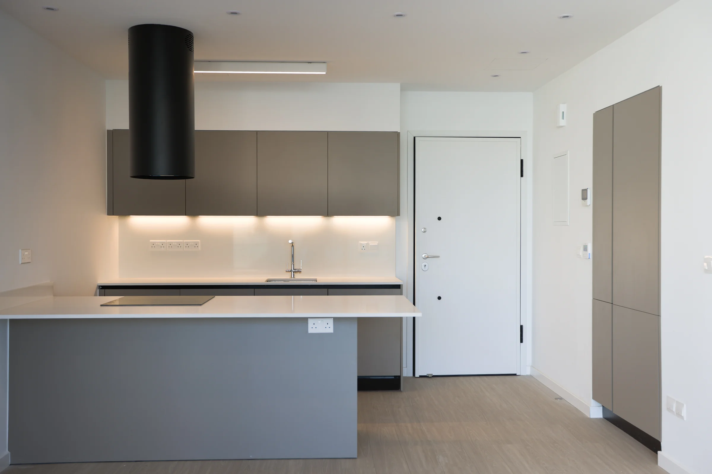 UKIYO kitchen with a black extractor hood over the island