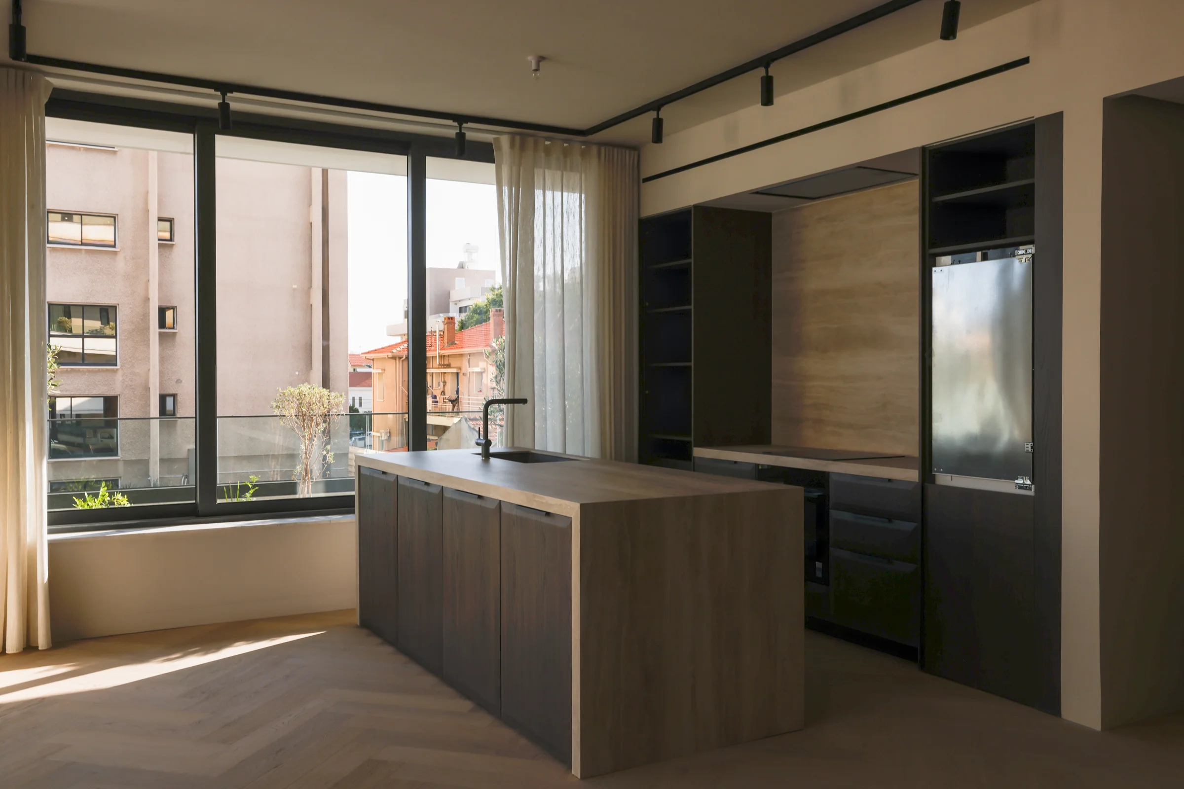 UKIYO kitchen with a dark timber island and window to the street