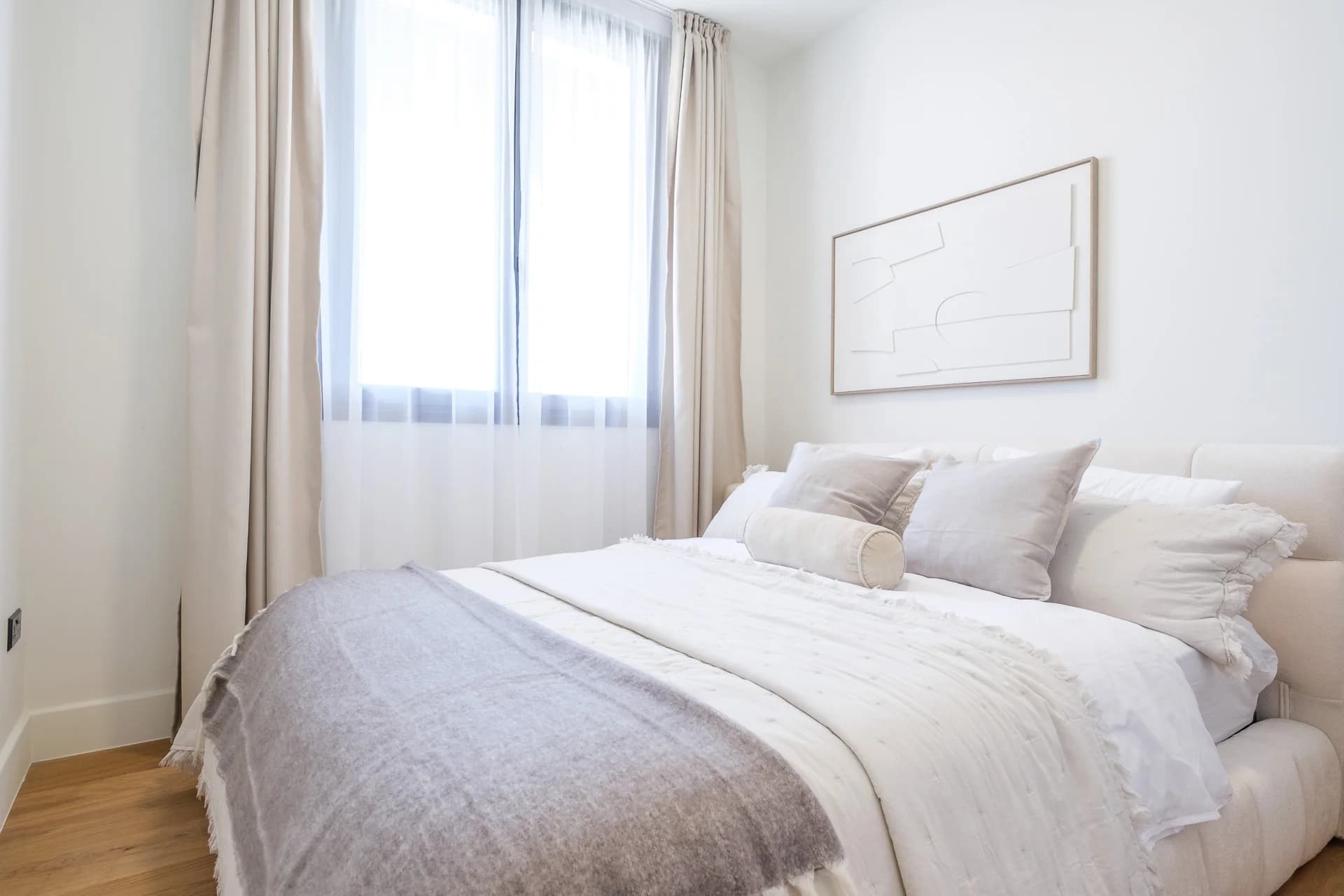 Bright URBN bedroom with linen bedding and sheer curtains