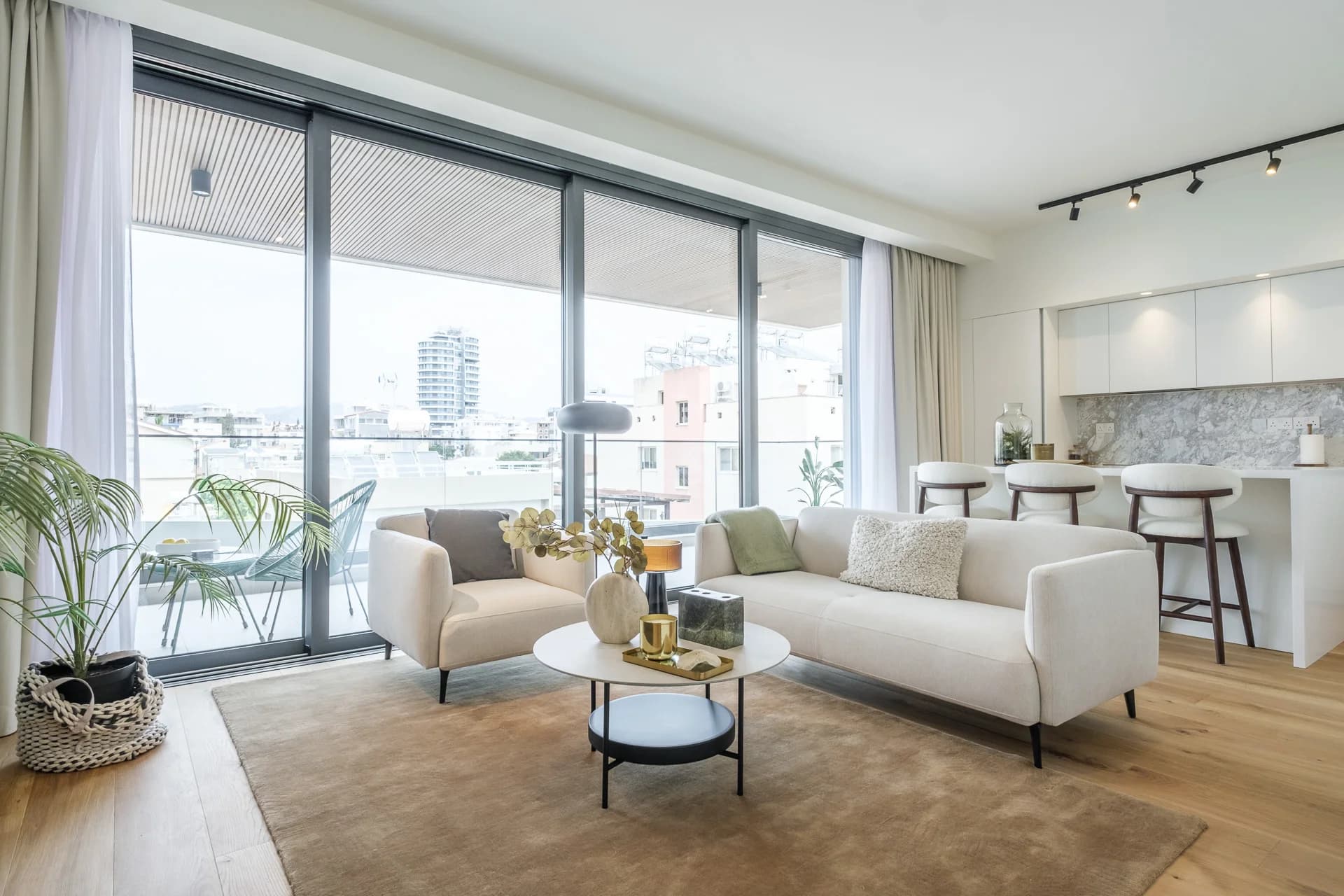Open-plan URBN living room and kitchen opening onto a balcony