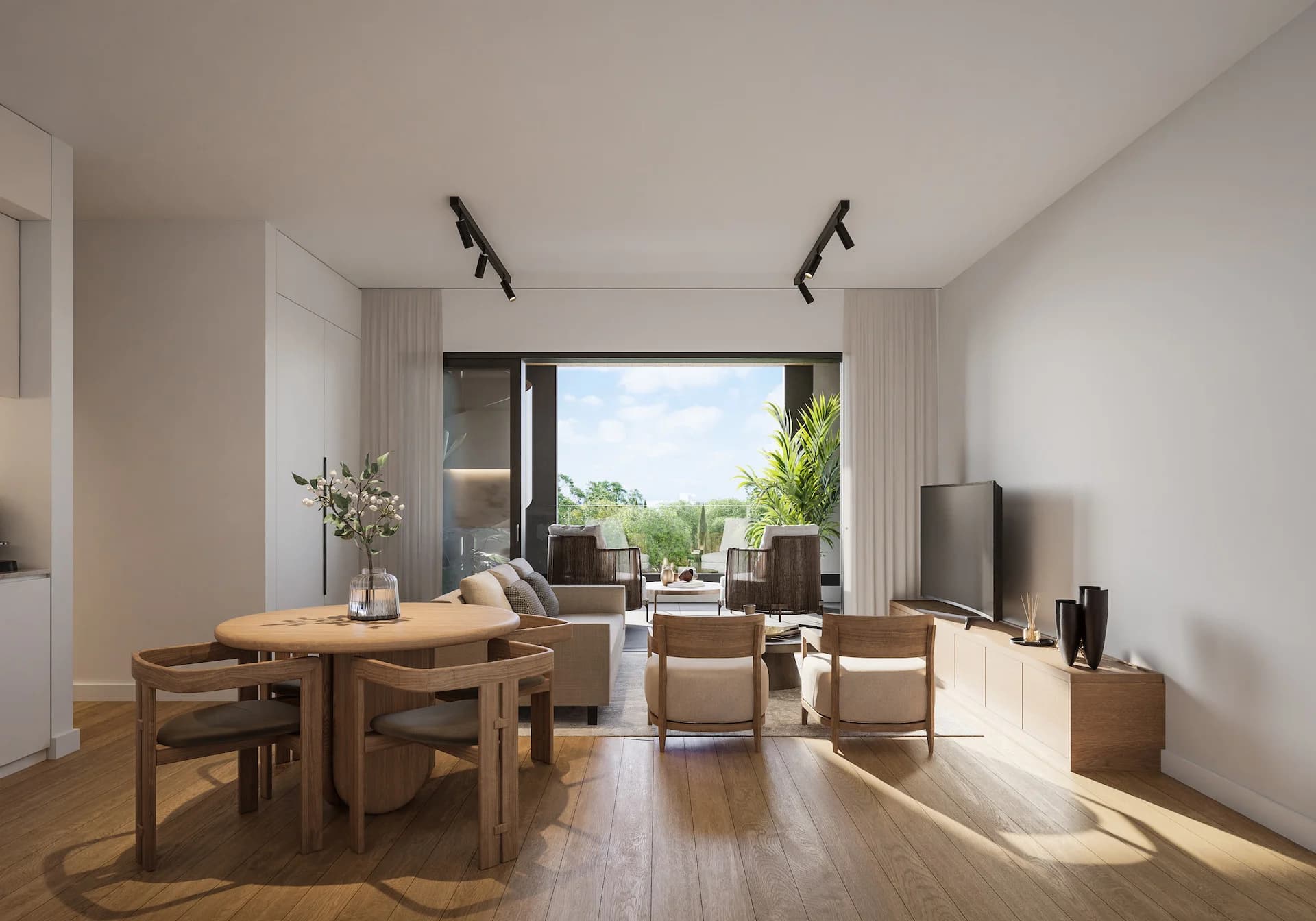 ZAYA living and dining room opening onto a terrace with trees beyond