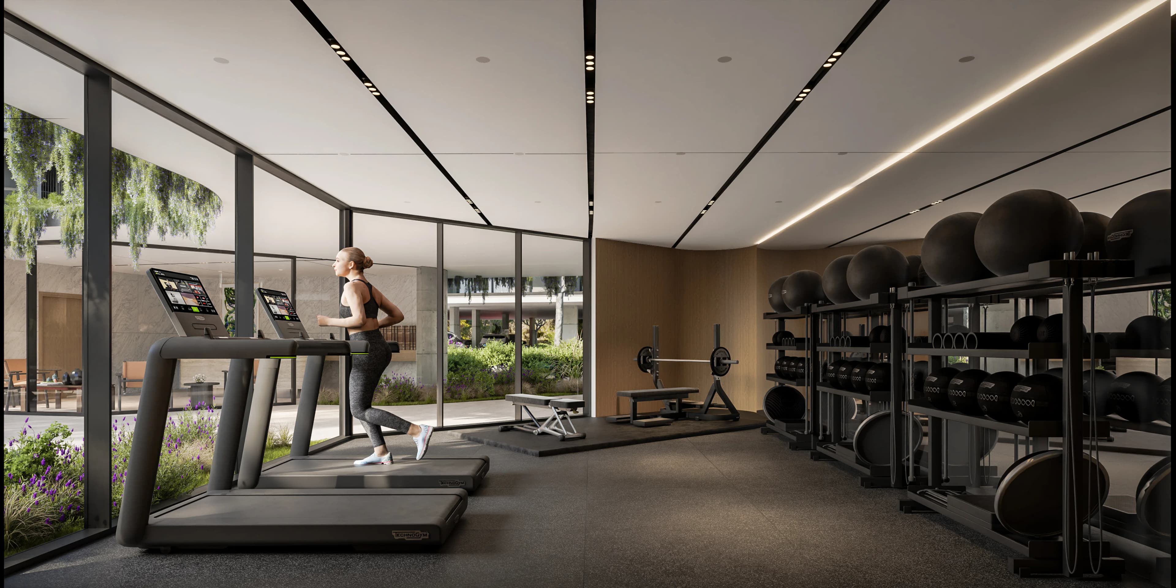 ZOIA gym with treadmills and weights behind floor-to-ceiling glass