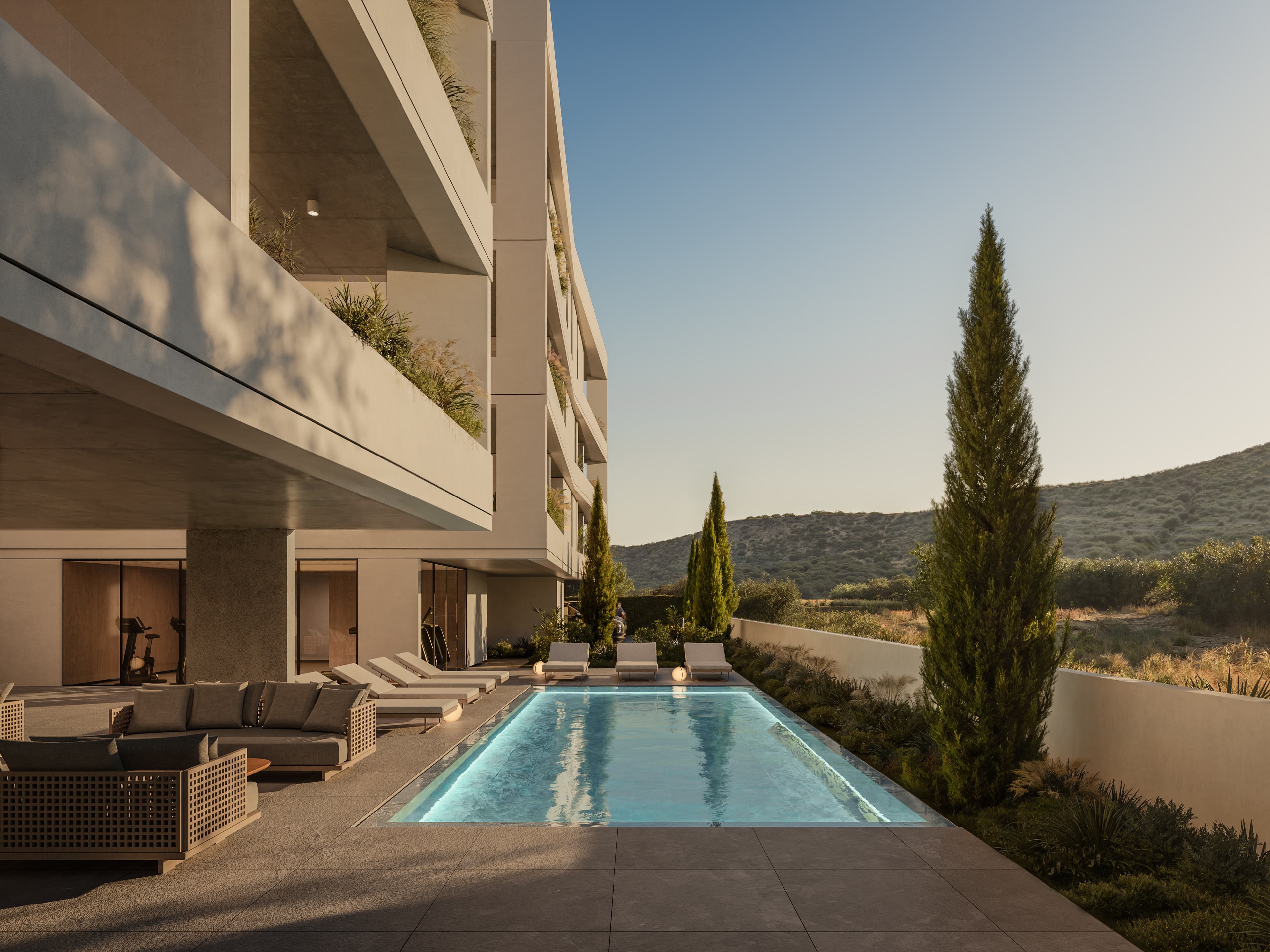 Communal swimming pool with sun loungers at ARYA