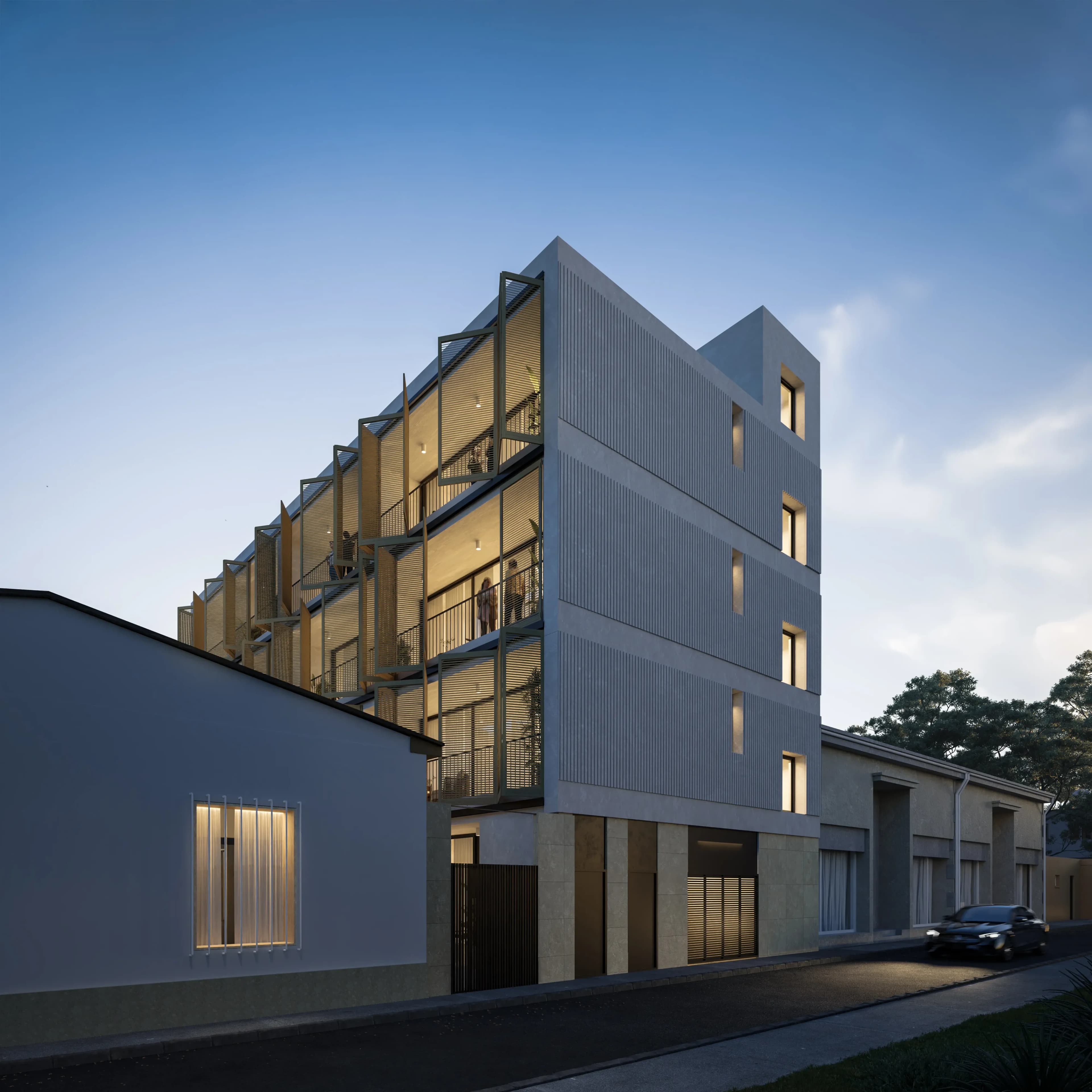 VIBE at dusk, its louvred facade lit from within above the rooftops of Limassol's old town