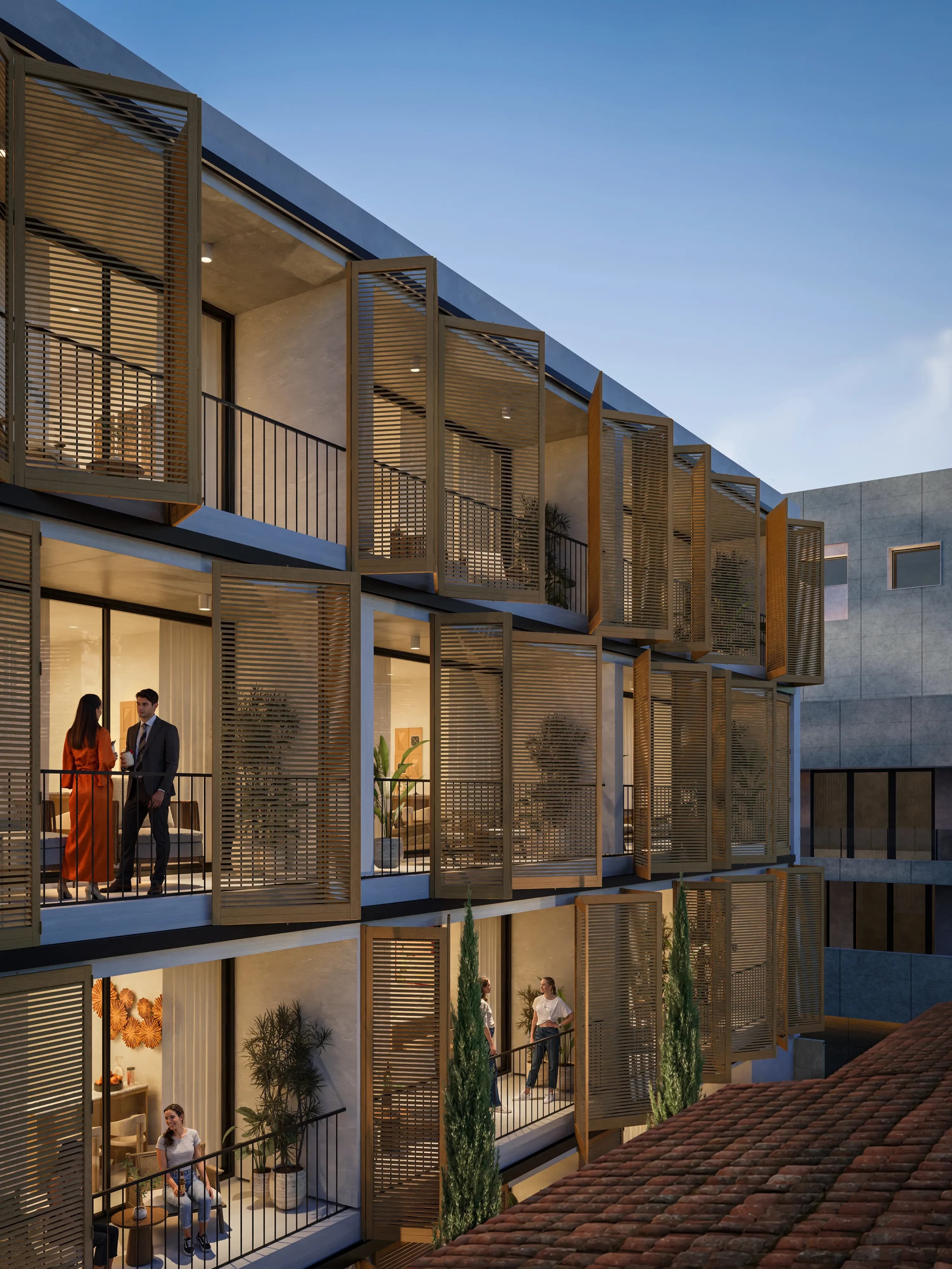 Residents on a VIBE veranda behind folding wooden shutters overlooking the courtyard