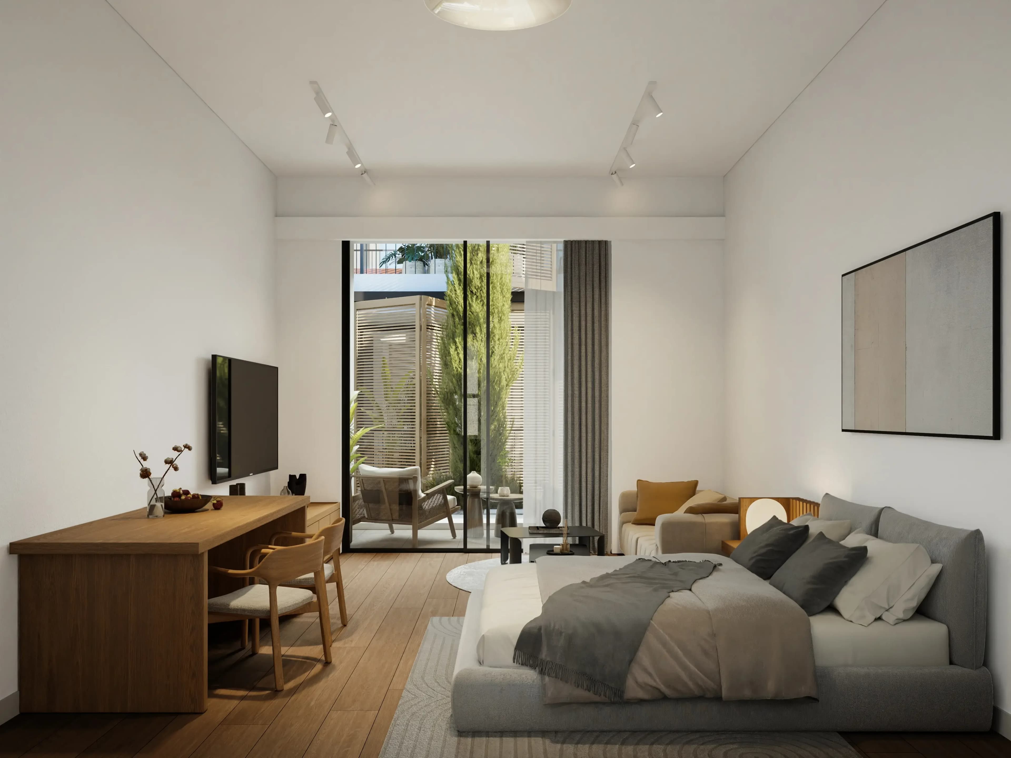 VIBE studio with bed, sofa and desk, opening onto a veranda and the courtyard
